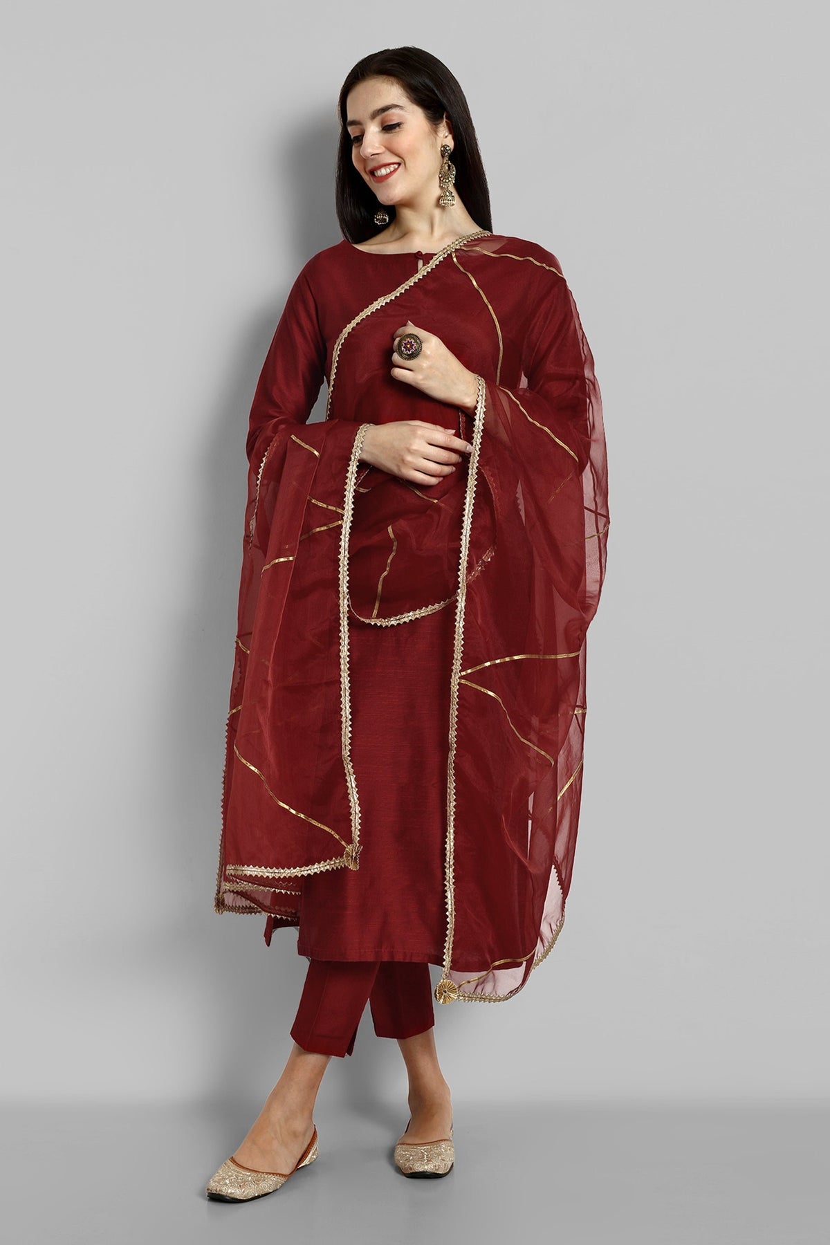 Maroon boat neck kurta paired with elasticated pants and an organza dupatta - a stylish set of three for a sophisticated and coordinated look