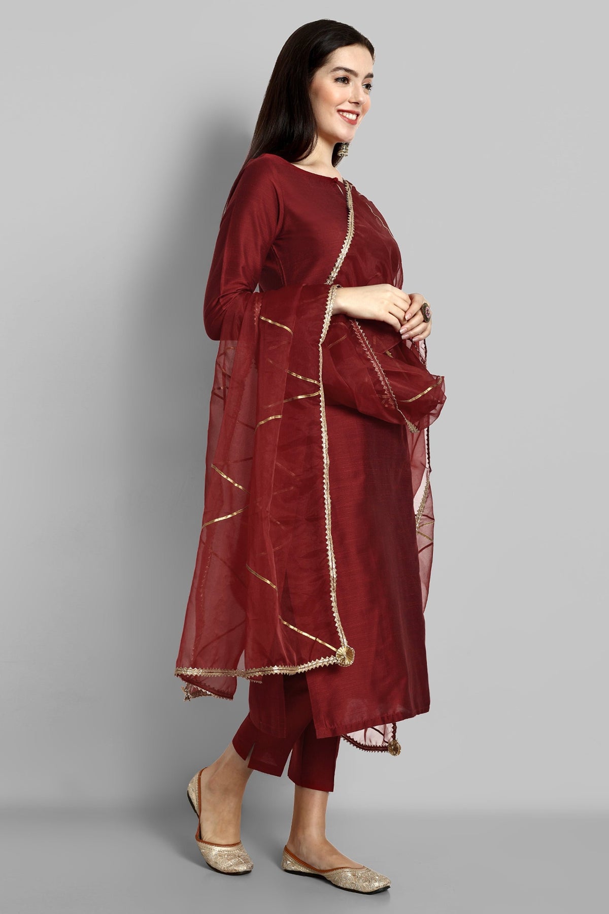 Maroon boat neck kurta paired with elasticated pants and an organza dupatta - a stylish set of three for a sophisticated and coordinated look